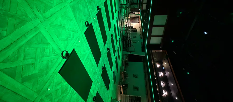 The session room in green light, mats laid on the floor.